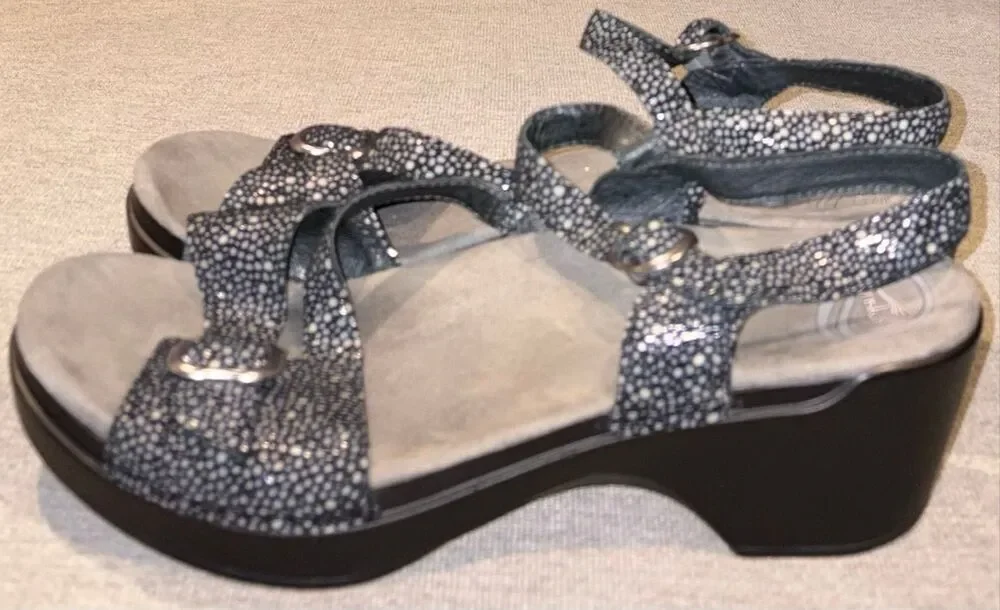 Dansko sandals, specifically the Sandi model featuring a black and white speckle